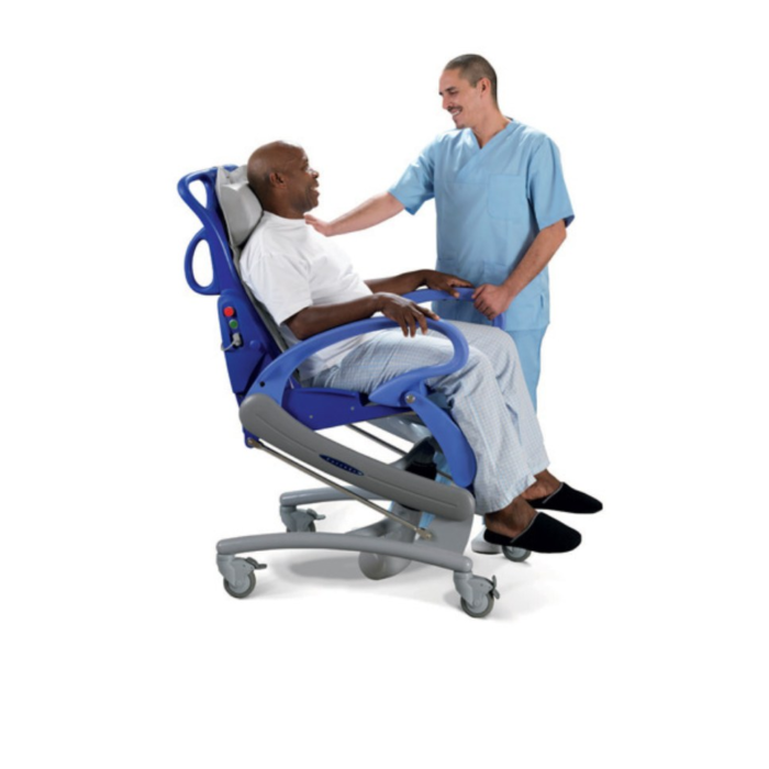A man sitting on a Carendo Hygiene Chair while a male nurse is watching.