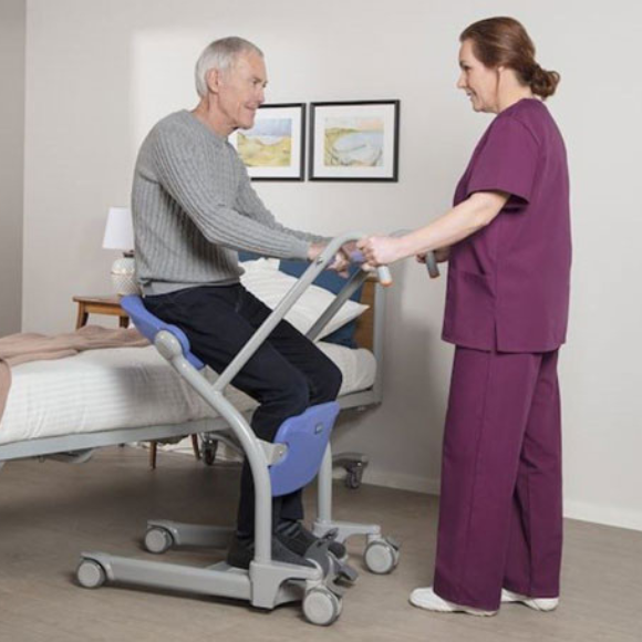 A patient getting on to a Sera Stedy with a help of a female nurse.